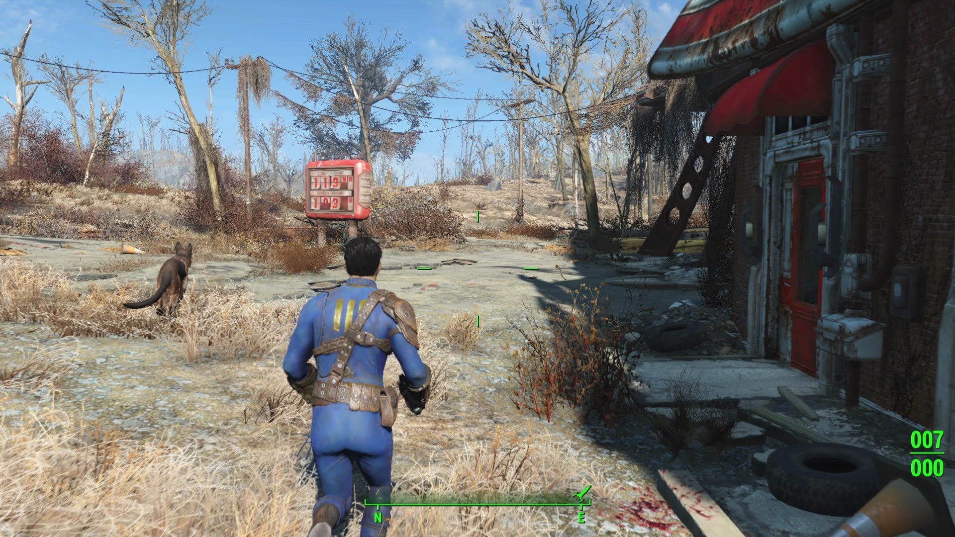 A vault dweller runs across the wasteland, passing a red building.