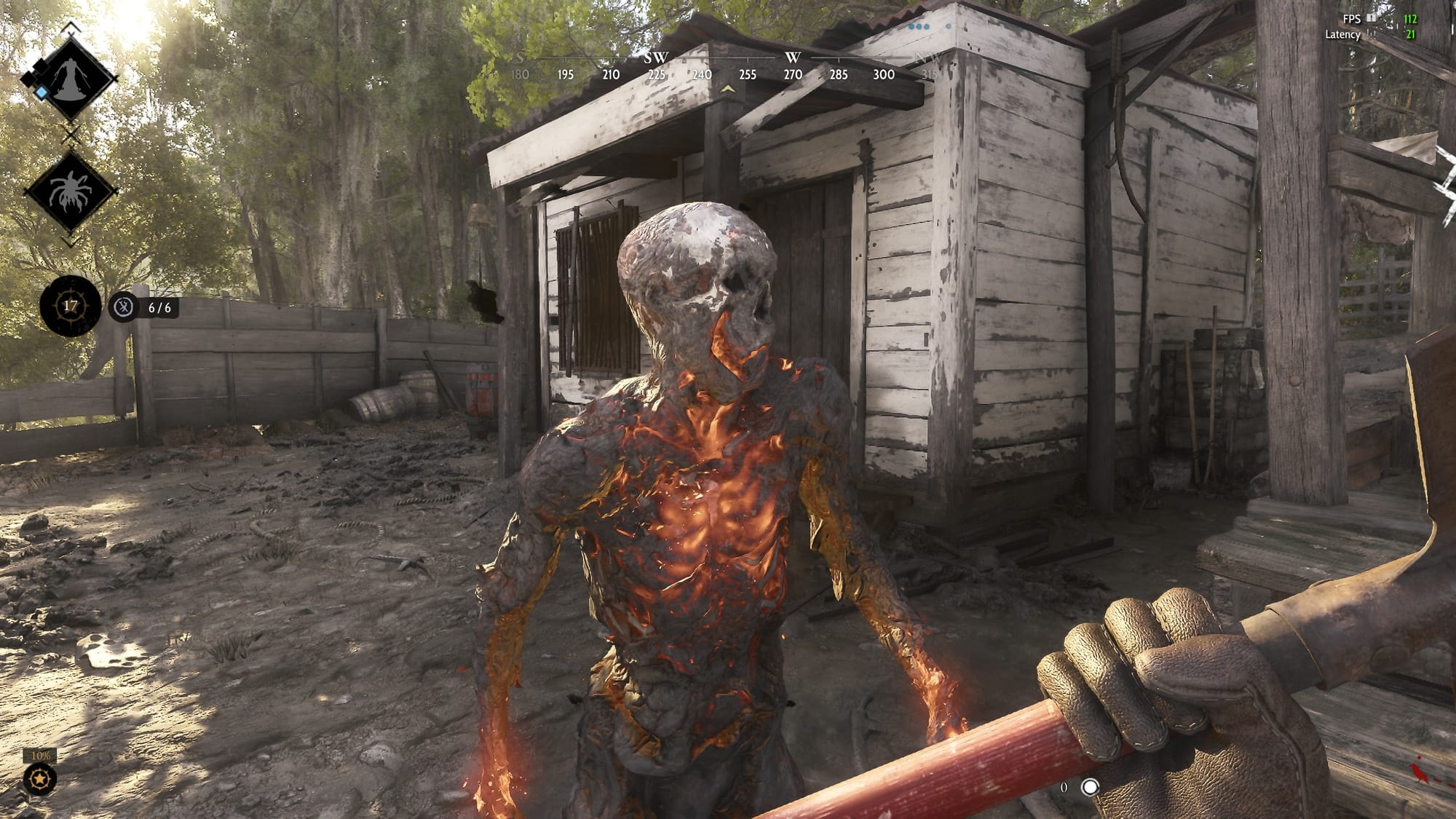 The player, gripping a shovel, faces a burning zombie in front of a shack.