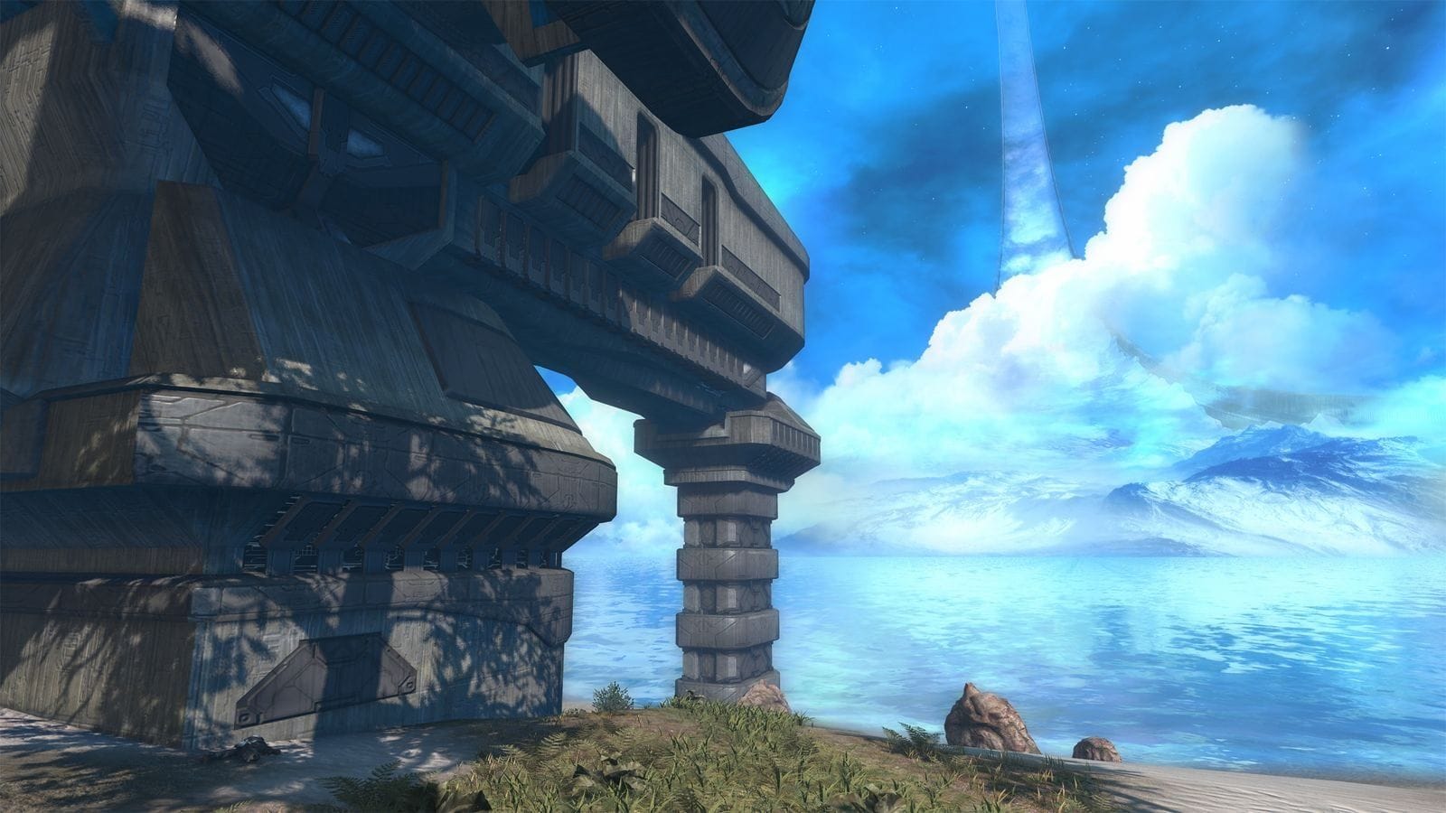 A Foreunner structure rests on a tropical beach with a ringworld visible in the sky.