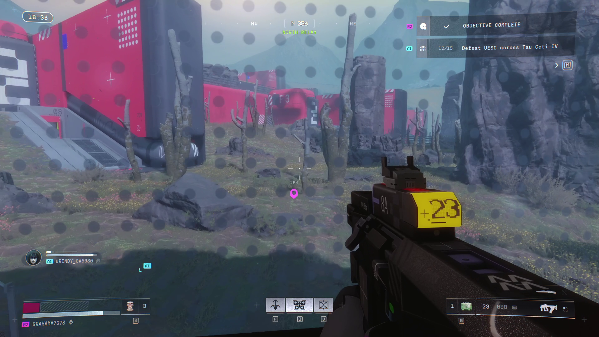 The view of some grassy terrain, viewed through glass with dots on it.