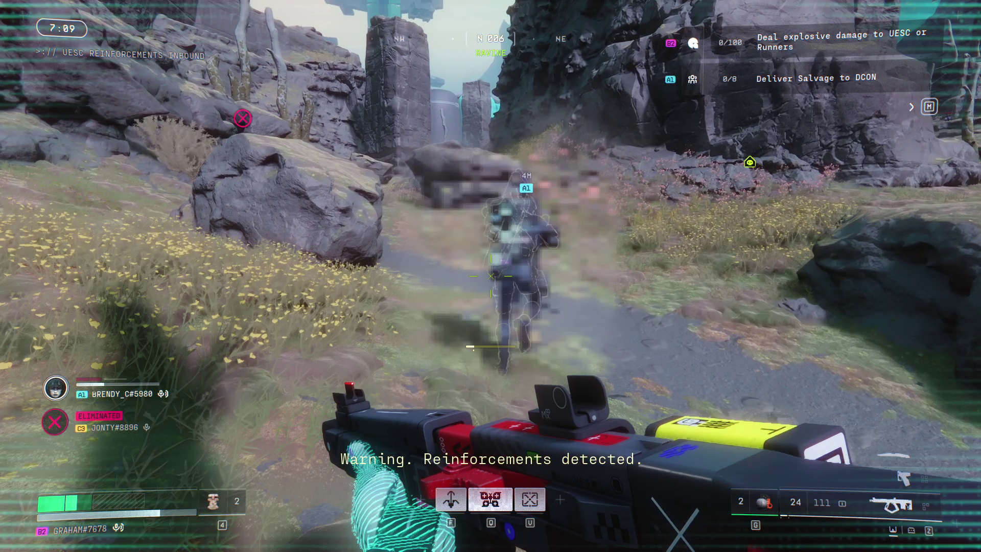 A pixelated player runs in a grey field next to grey rocks.