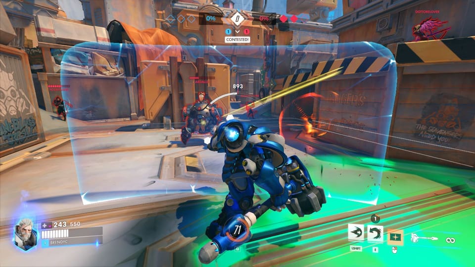 Reinhardt holds a holographic shield as he comes under fire from Hammond and other heroes.