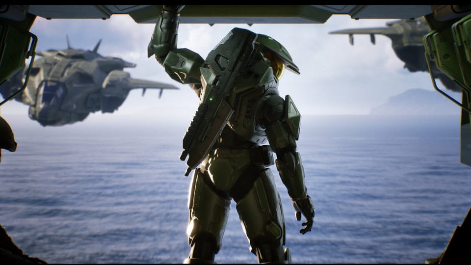 Master Chief looking out of the back of Pelican craft as it flies over water.